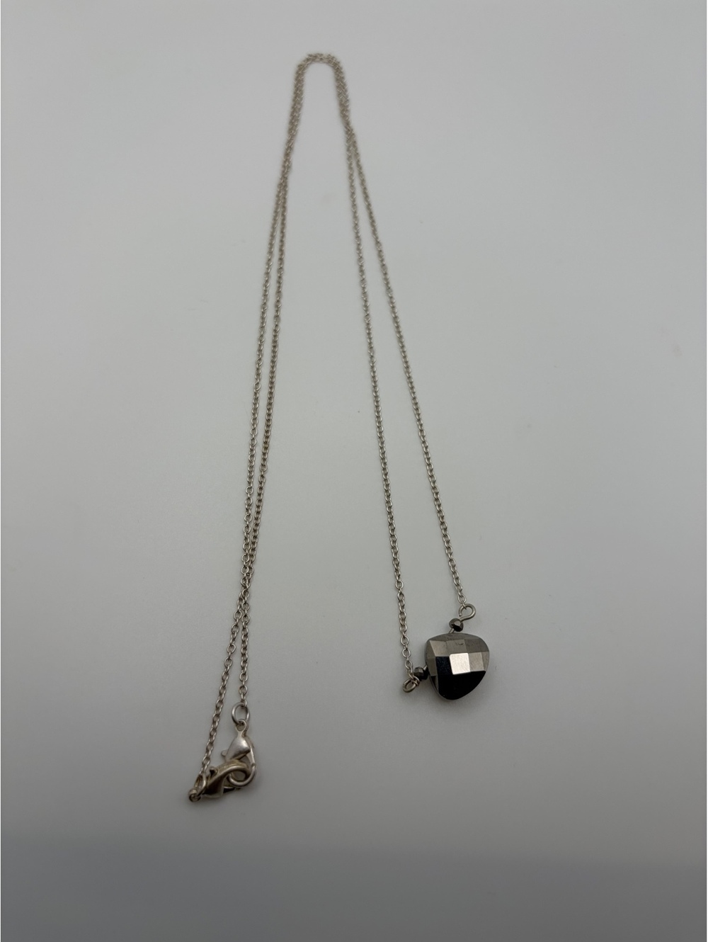 Silver tone faceted heart pendant necklace